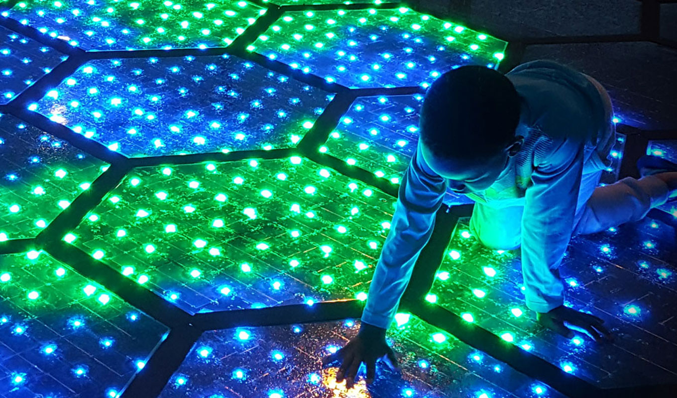 Episode 4 Solar Roadways - young boy playing on solar lit roadway