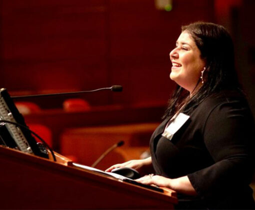 Jennifer Lynn Robinson at podium addressing students