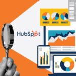 hand holding magnifying glass highlighting HubSpot logo and data