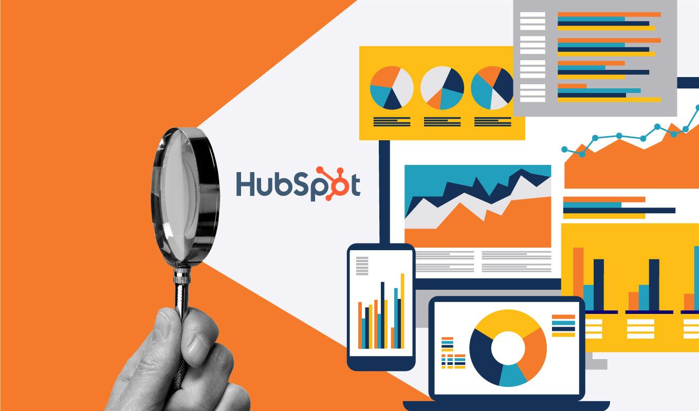 hand holding magnifying glass highlighting HubSpot logo and data