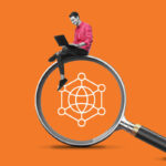 Man with laptop sitting on magnifying glass with web icon in center