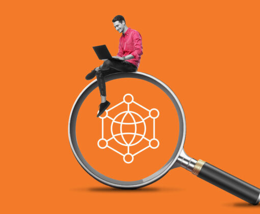 Man with laptop sitting on magnifying glass with web icon in center