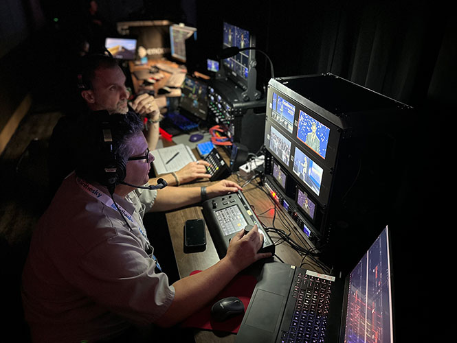 men looking at video monitors
